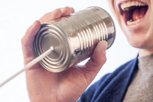 Man using a tin can to communicate